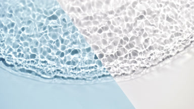 Single wave of clear fluid ripples on multicolored background