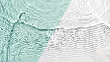 Wave makes ripples on water surface over green and white bg