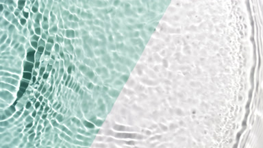 Wave makes ripples on water surface on green and white bg