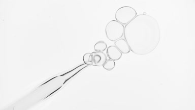 Bubbles come out from dropper and float on surface of liquid