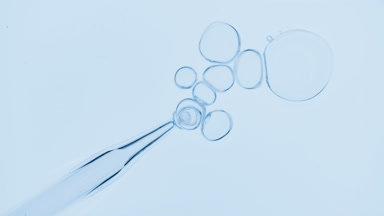 Bubbles come out from dropper and float on surface of liquid
