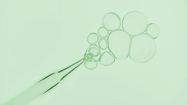 Bubbles comes out from dropper and float on surface of liquid