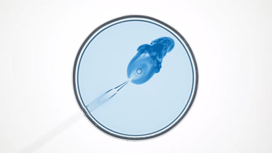 Lab dropper injects blue liquid into pale blue one in Petri dish