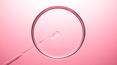 Chemical dropper injects oil into clear fluid in Petri dish