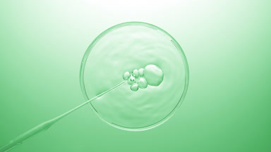 Air bubbles coming out from dropper and floating on clear fluid