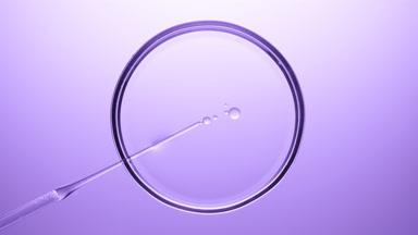 Chemical dropper injects oil into clear liquid in Petri dish