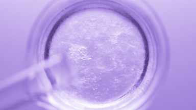 Glycerin pouring into beaker with water creates ripples