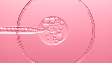 Gel with bubbles comes out from lab dropper into Petri dish