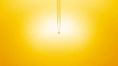 Clear liquid is dripped from graduated chemical dropper