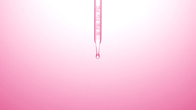 Clear fluid is dripped from graduated chemical dropper