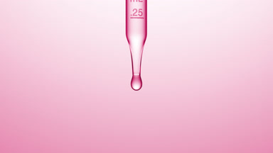 Transparent fluid is dripped from graduated lab dropper