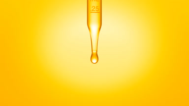 Transparent fluid is dripped from graduated lab dropper