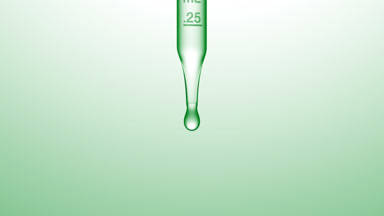 Transparent fluid is dripped from graduated lab dropper