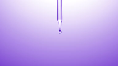 Clear drops are falling down from chemical dropper