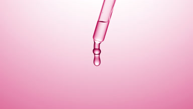 Transparent drops are falling down from chemical dropper