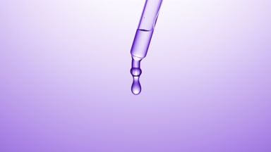 Transparent drops are falling down from chemical dropper
