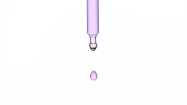 Violet drop is falling down from chemical dropper