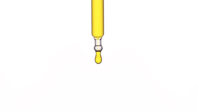 Yellow drop is falling down from chemical dropper