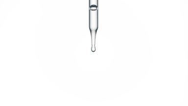 Drop of hyaluronic acid is falling down from chemical dropper