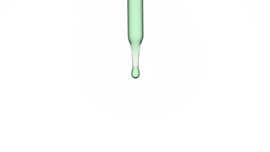 Drops of hemp oil are falling down from lab dropper