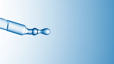 Clear drops are falling down from chemical dropper