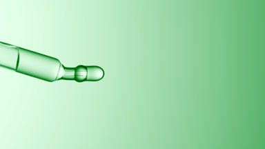 Clear drops are falling down from chemical dropper
