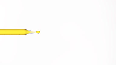 Yellow drop is dripping from lab dropper