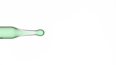 Green drops are dripping from graduated lab dropper