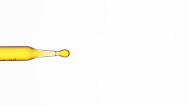 Yellow fluid is dripped from graduated chemical dropper