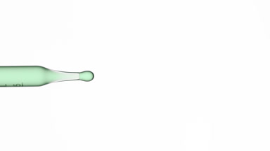 Green fluid is dripped from graduated chemical dropper