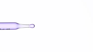 Violet fluid is dripped from graduated lab pipette