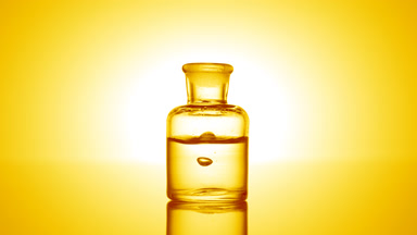Drop falling into old fashioned bottle with clear liquid