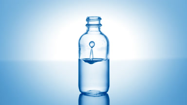 Hypochlorous acid falls into medical bottle with blue liquid