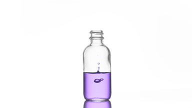 Niacinamide is falling into medical bottle with purple liquid