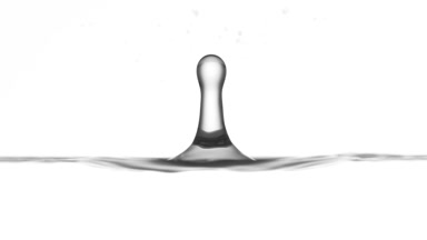 Drop of cucumber extract falls on grey liquid creating ripples