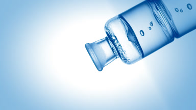 Hypochlorous acid drips into old fashioned bottle with liquid