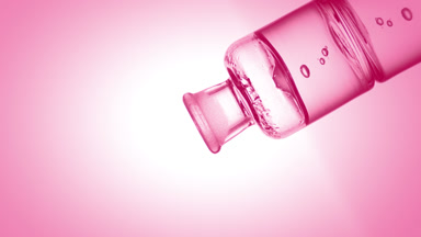 Lactic acid drips into old fashioned bottle with pink liquid
