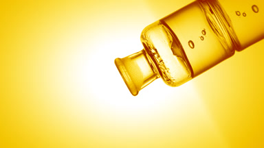 Ascorbic acid drips into old fashioned bottle with yellow liquid
