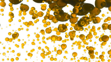 Chamomile oil is poured into water creating yellow bubbles