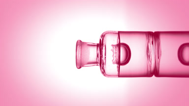 Drop falling into old fashioned bottle with transparent liquid