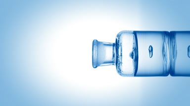 Drop of hypochlorous acid falls into bottle with blue fluid