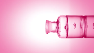Drop of lactic acid falls into bottle with pink fluid