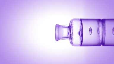 Drop of salicylic acid falls into bottle with purple fluid