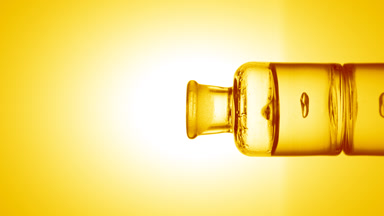 Drop of ascorbic acid falls into bottle with yellow fluid