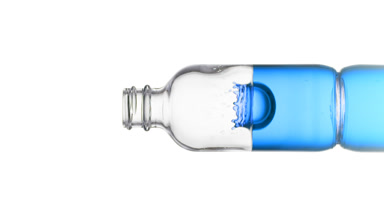 Drop of biotin falls down into medical bottle with blue fluid