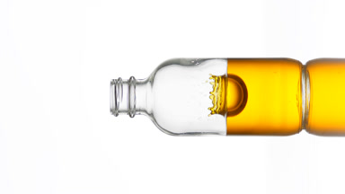 Drop of vitamin C falls into medical bottle with yellow fluid