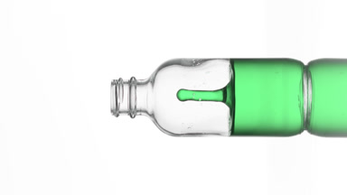 Drop of vitamin K falls into medical bottle with green fluid
