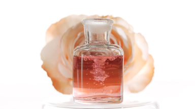 Rose water is dripping into reagent bottle creating bubbles