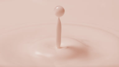 Rose milk drop is falling on milk surface creating circles