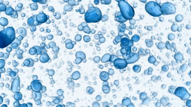 A lot of blue different sized bubbles swirling in clear liquid